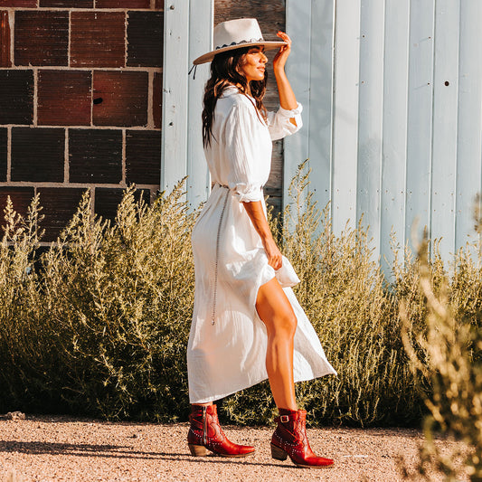 FREEBIRD women's Morgan red leather ankle bootie with silver stud embellishments, gore detailing, and buckle straps lifestyle image