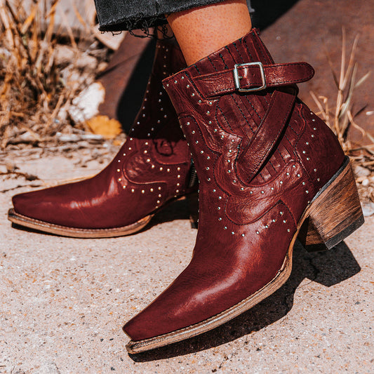 FREEBIRD women's Morgan red leather ankle bootie with silver stud embellishments, gore detailing, and buckle straps