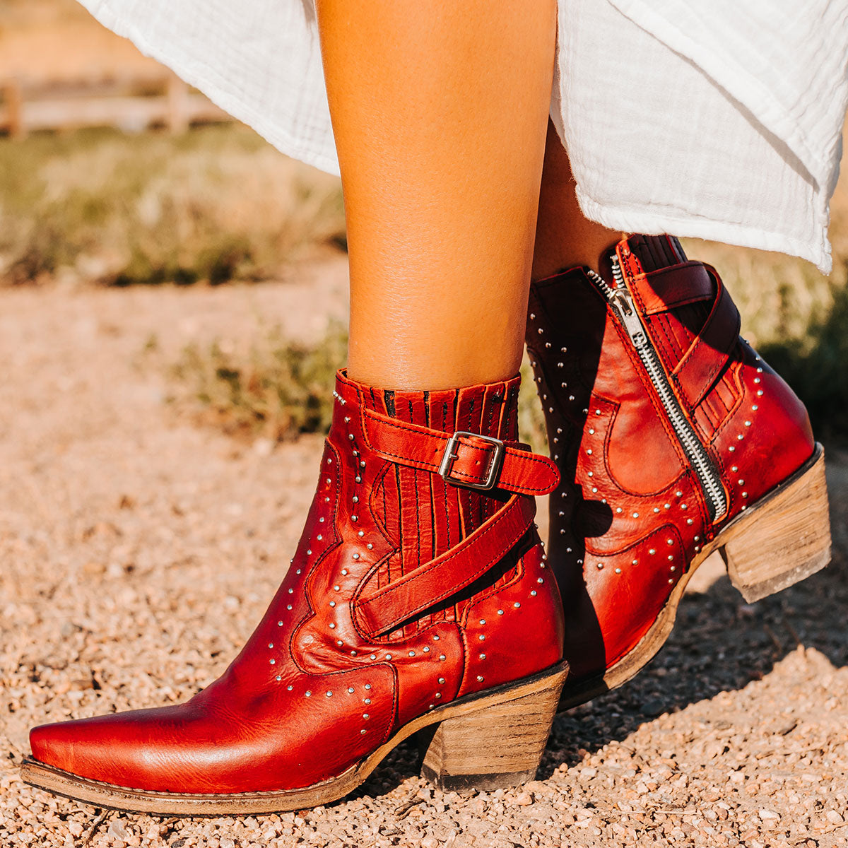 FREEBIRD women's Morgan red leather ankle bootie with silver stud embellishments, gore detailing, and buckle straps