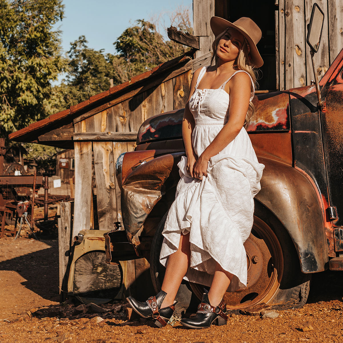 FREEBIRD women's Mystic black leather belted embellished bootie with ankle framing cuts lifestyle image