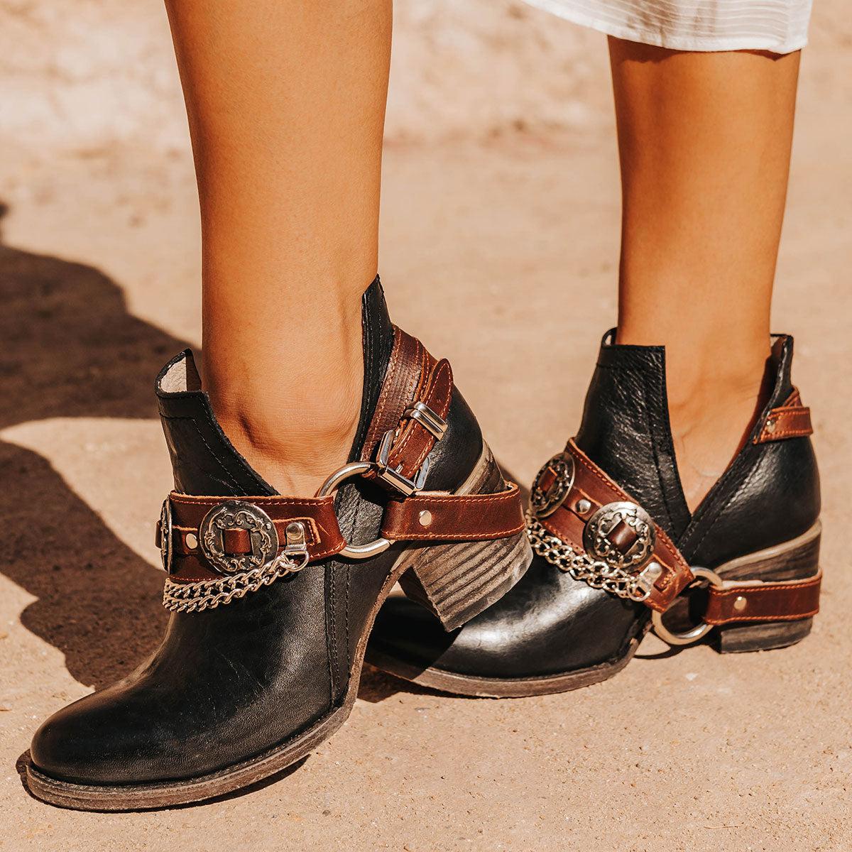 FREEBIRD women's Mystic black leather belted embellished bootie with ankle framing cuts