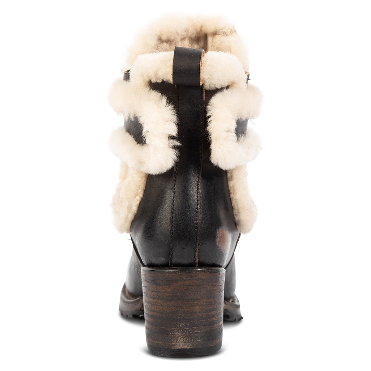 Back view showing FREEBIRD women's Neverland black leather bootie with genuine shearling removable lining, gore detailing and a stacked heel
