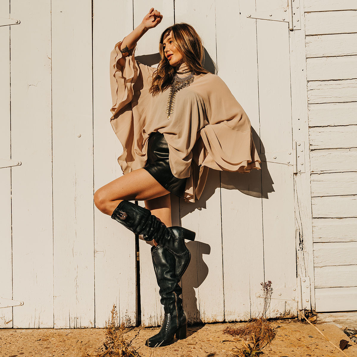 FREEBIRD women's Paisley black suede knee high boot with whipstitch detailing and brass zip closure lifestyle image
