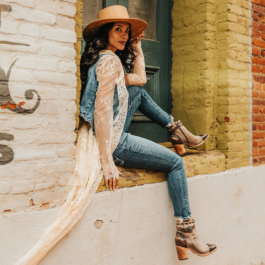 FREEBIRD women's Poppy Beige suede bootie with high heel, inside zip closure, decorative belt, and floral detailing lifestyle