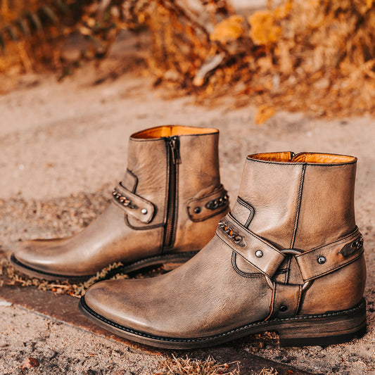 FREEBIRD men's Portland black leather boot featuring a leather ankle harness with brass chainlink detail, a working inside zip closure and low block heel