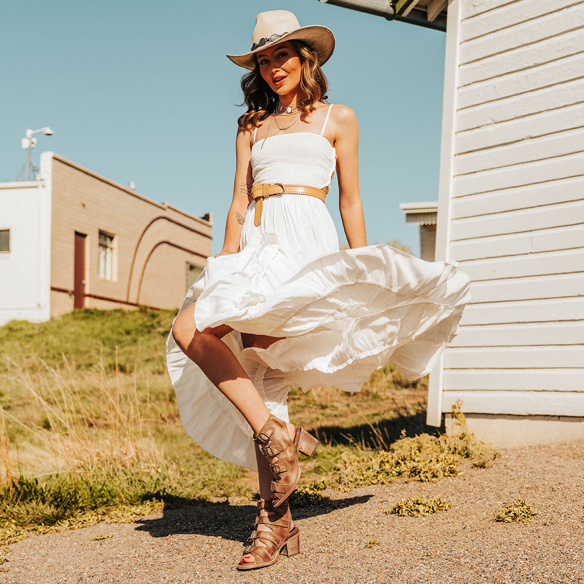 FREEBIRD women's Quail honey sandal with leather straps and working brass buckles lifestyle image