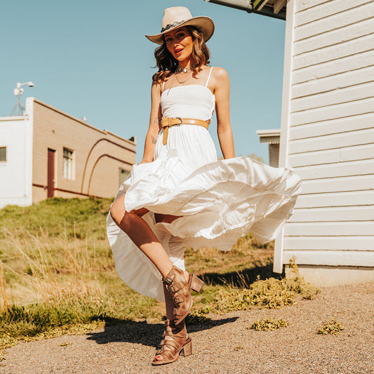 FREEBIRD women's Quail honey sandal with leather straps and working brass buckles lifestyle image