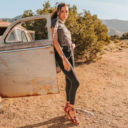 FREEBIRD women's Rodeo red multi leather sandal with silver stud embellishments, adjustable gold buckle detailing and a lifted inverted heel lifestyle