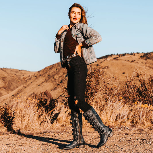 FREEBIRD women's Rory navy leather boot with leather straps stacking up the front shaft and inside zip closure lifestyle