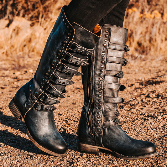 FREEBIRD women's Rory navy leather boot with leather straps stacking up the front shaft and inside zip closure