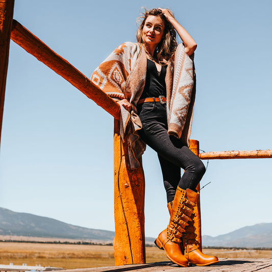 FREEBIRD women's Rory wheat leather boot with leather straps stacking up the front shaft and inside zip closure lifestyle