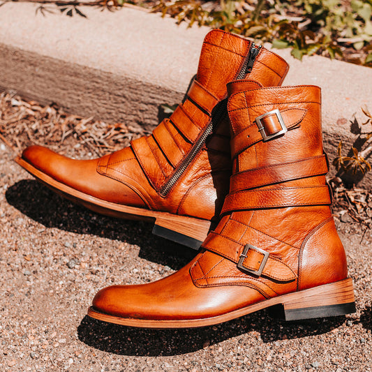 FREEBIRD men's Rumble whiskey leather boot with adjustable leather straps, a working brass zipper and stacked heel