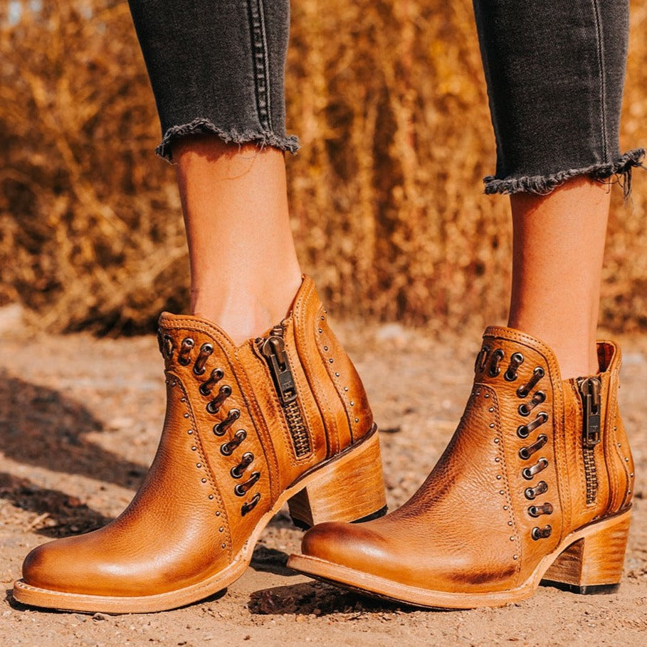 FREEBIRD women's Ryder wheat leather bootie with inside zip closures, eyelet whip stitch leather detailing and an almond toe.