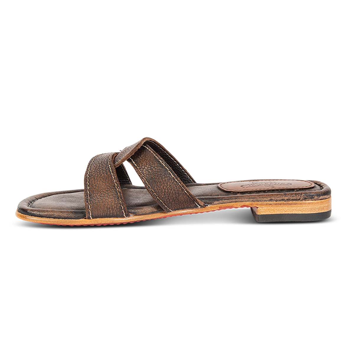Inside view showing FREEBIRD criss-cross leather foot strap on women's Sawyer black low heeled sandal