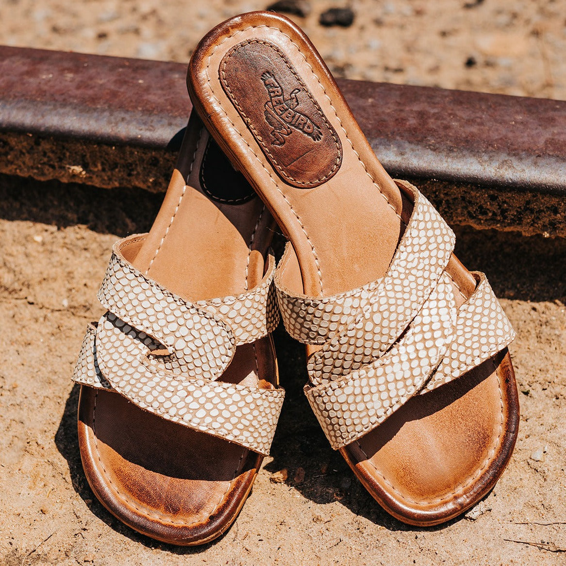 FREEBIRD women's Sawyer white snake low heeled slip on sandal featuring criss-cross leather foot straps