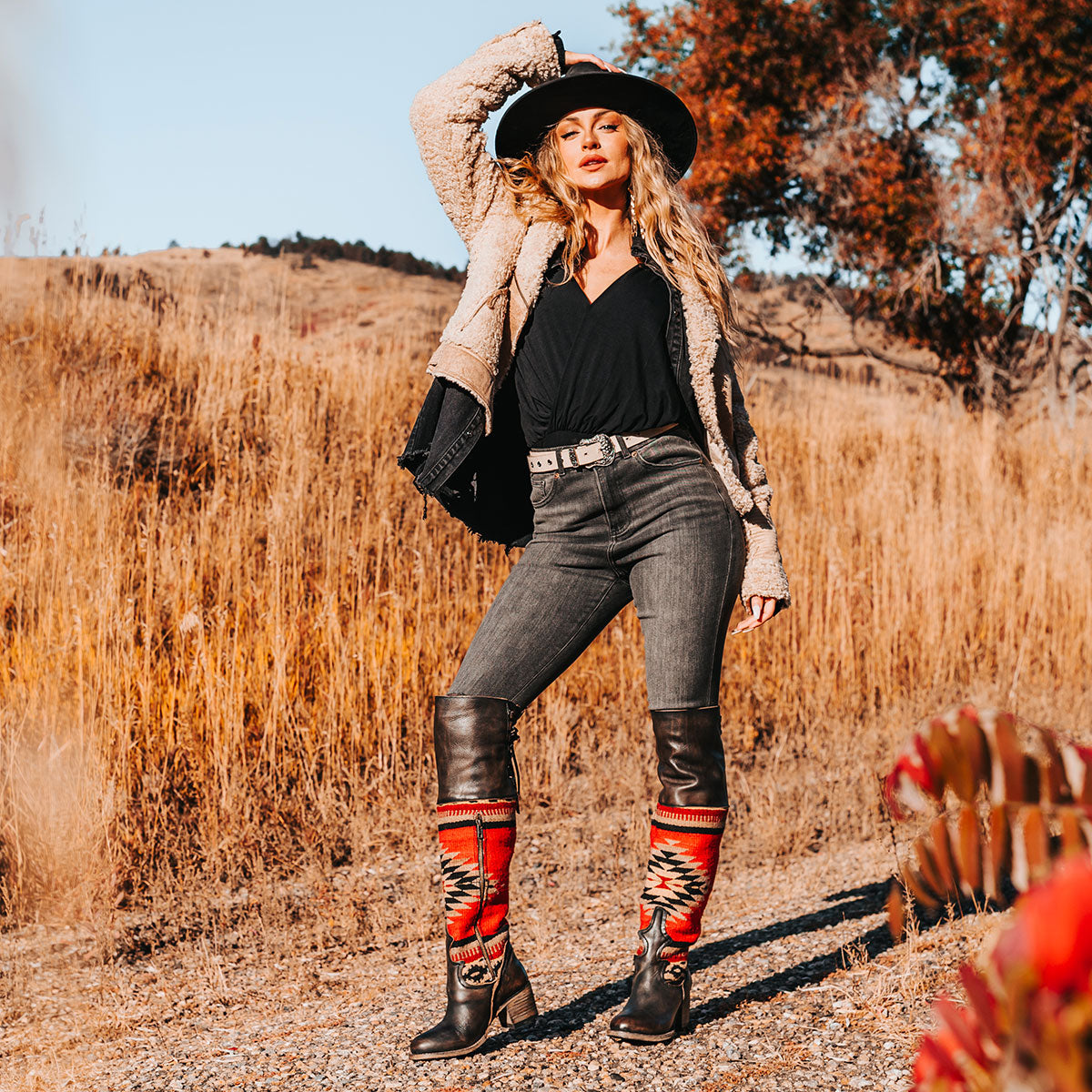 FREEBIRD women's Serape black leather knee high boot with woven detailing, leather tie lacing and an inside working brass zip closure lifestyle