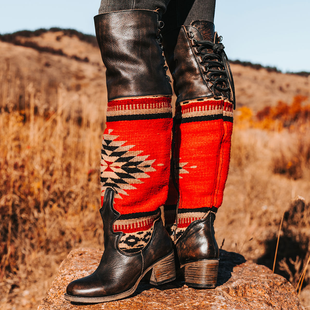 FREEBIRD women's Serape black leather knee high boot with woven detailing, leather tie lacing and an inside working brass zip closure
