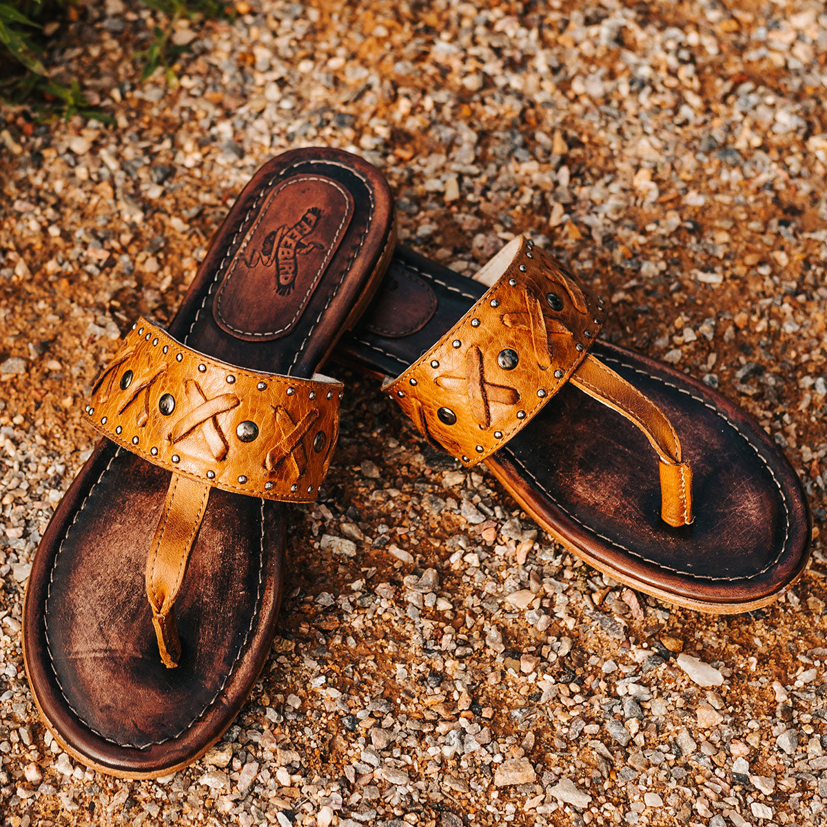 FREEBIRD women's Shay wheat low heeled slip on sandal featuring woven leather foot strap with stud embellishments