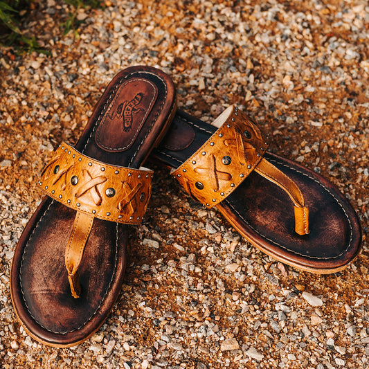 FREEBIRD women's Shay wheat low heeled slip on sandal featuring woven leather foot strap with stud embellishments