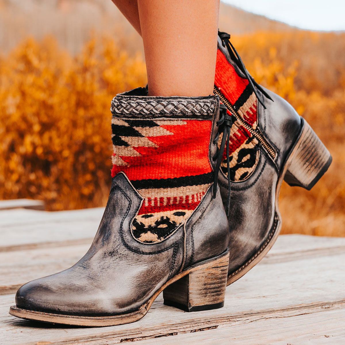 FREEBIRD women's Songbird black leather bootie with woven detailing, leather tie lacing and an inside working brass zip closure