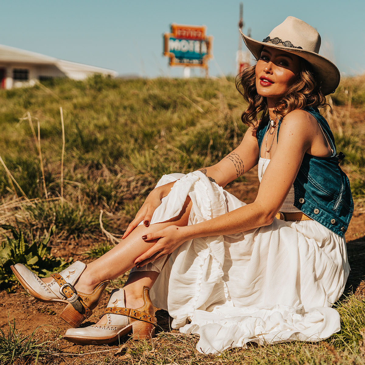 FREEBIRD women's Stardom beige bootie with silver stud detailing, laser cut leather, open ankles, and a decorative ankle strap lifestyle image