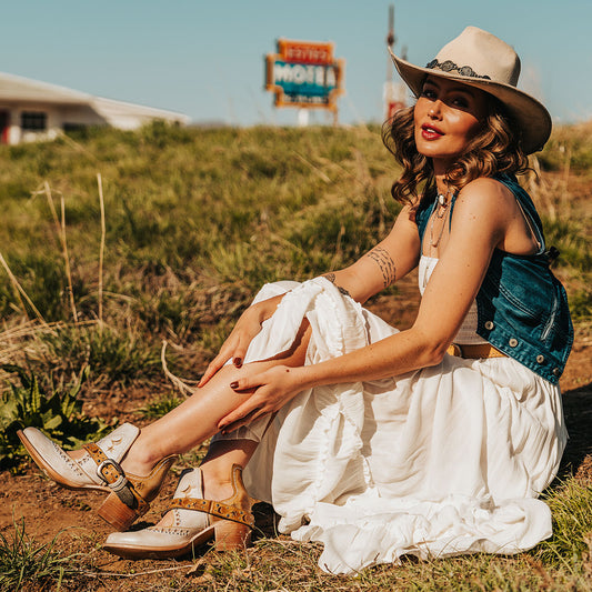 FREEBIRD women's Stardom beige bootie with silver stud detailing, laser cut leather, open ankles, and a decorative ankle strap lifestyle image