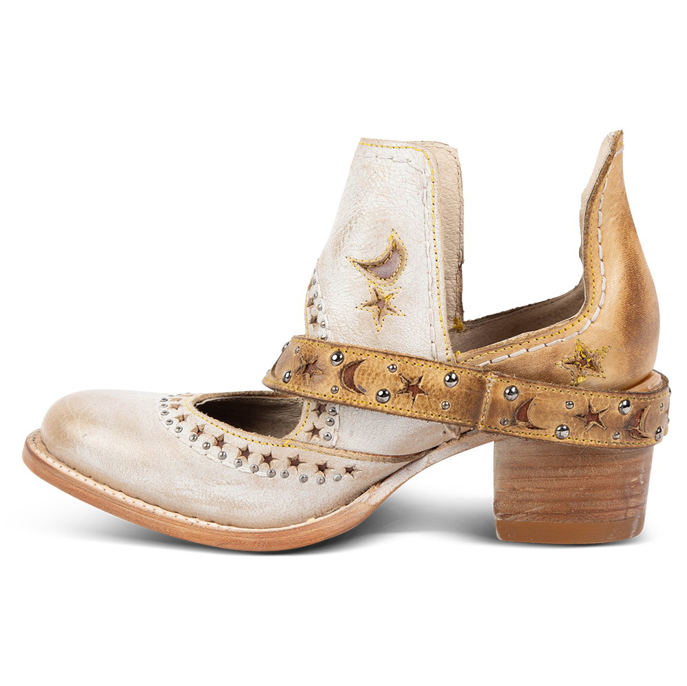Side view showing a decorative ankle strap, silver stud detailing, and exposed ankles on FREEBIRD women's Stardom beige bootie