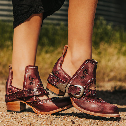 FREEBIRD women's Stardom wine bootie with silver stud detailing, laser cut leather, open ankles, and a decorative ankle strap