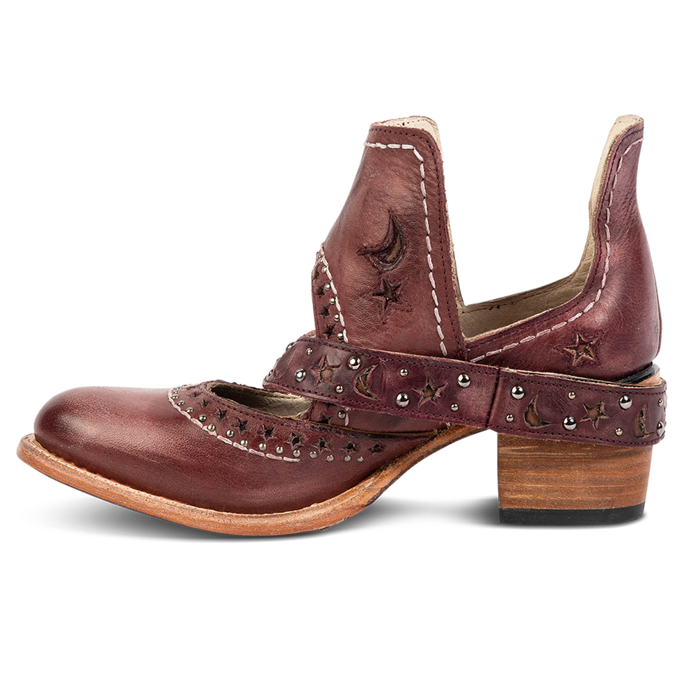 Side view showing a decorative ankle strap, silver stud detailing, and exposed ankles on FREEBIRD women's Stardom wine bootie