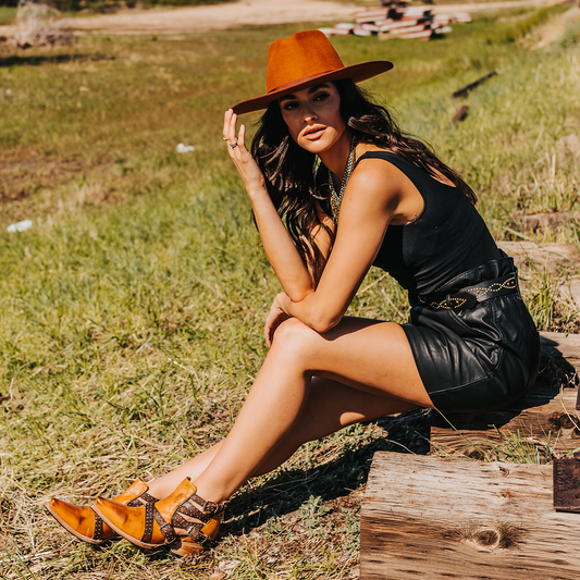 FREEBIRD women's Wasp wheat ankle bootie with exposed sides, adjustable fastener metal buckles, working back zip closure, snip toe, and traditional snip toe