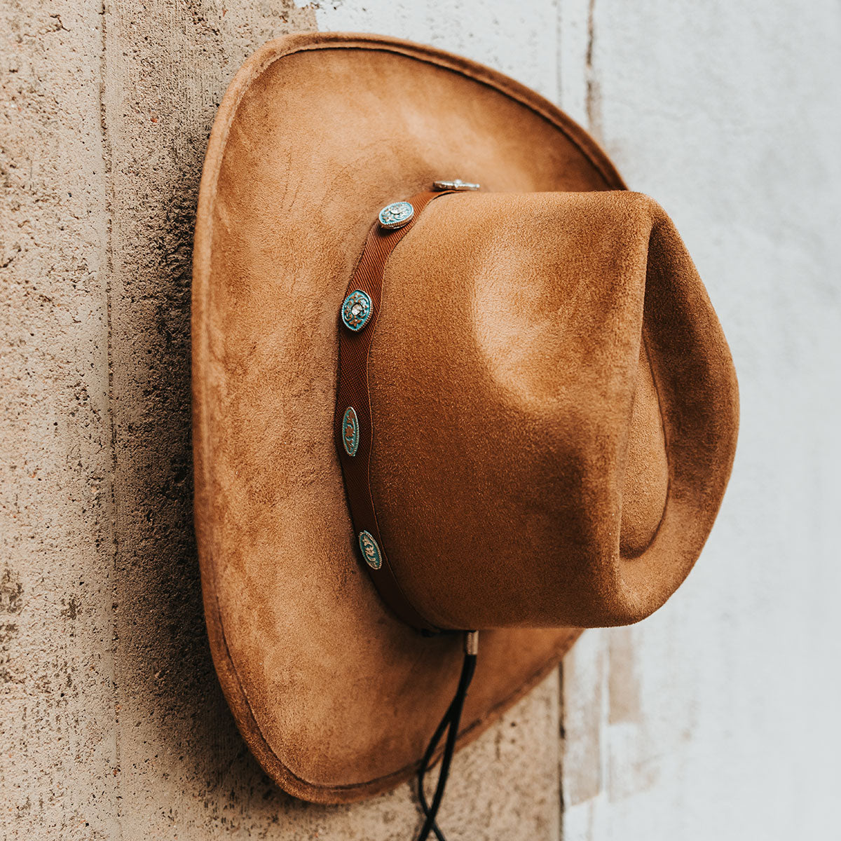 FREEBIRD Wesson camel distressed cowboy hat featuring teardrop crown, western curved brim, and turquoise metal detailing