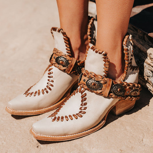 FREEBIRD women's Whimsical off white leather bootie with whip stitch detailing, leather braided belt and snip toe construction