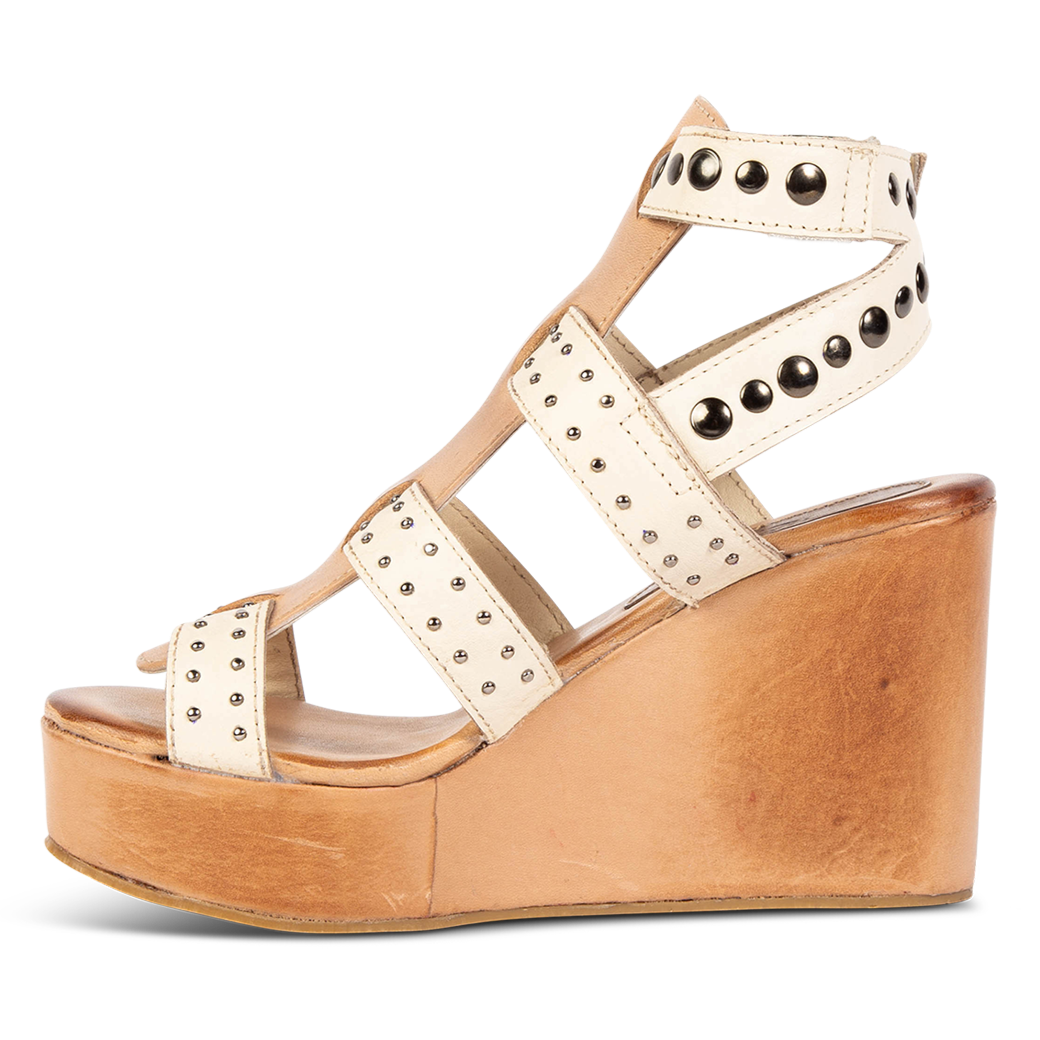Inside view showing wedge heel on FREEBIRD women's Winter beige multi platform sandal featuring an adjustable ankle strap and stud detailing