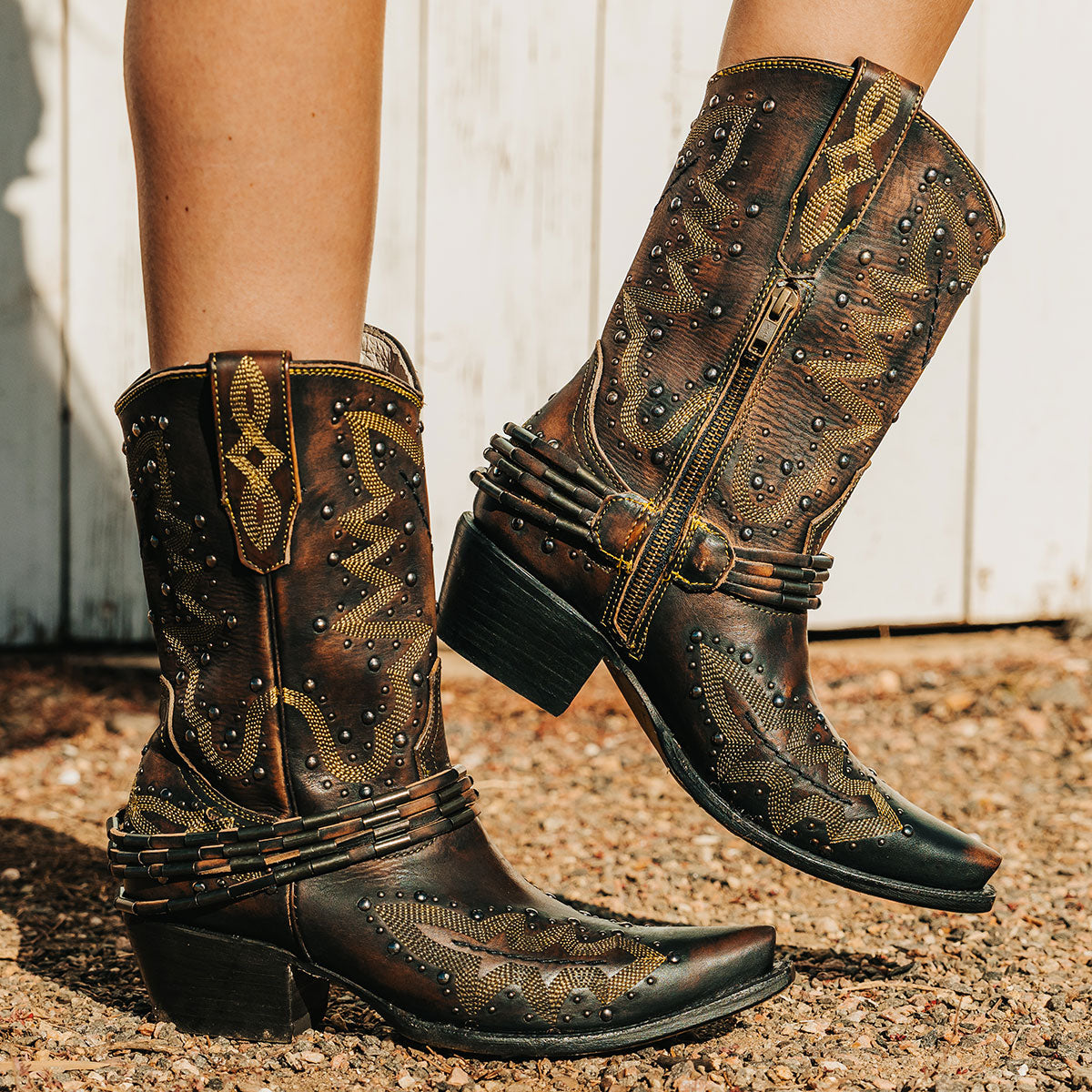 FREEBIRD women's Wisteria black boot with western stitching, silver stud detailing, and decorative ankle belting