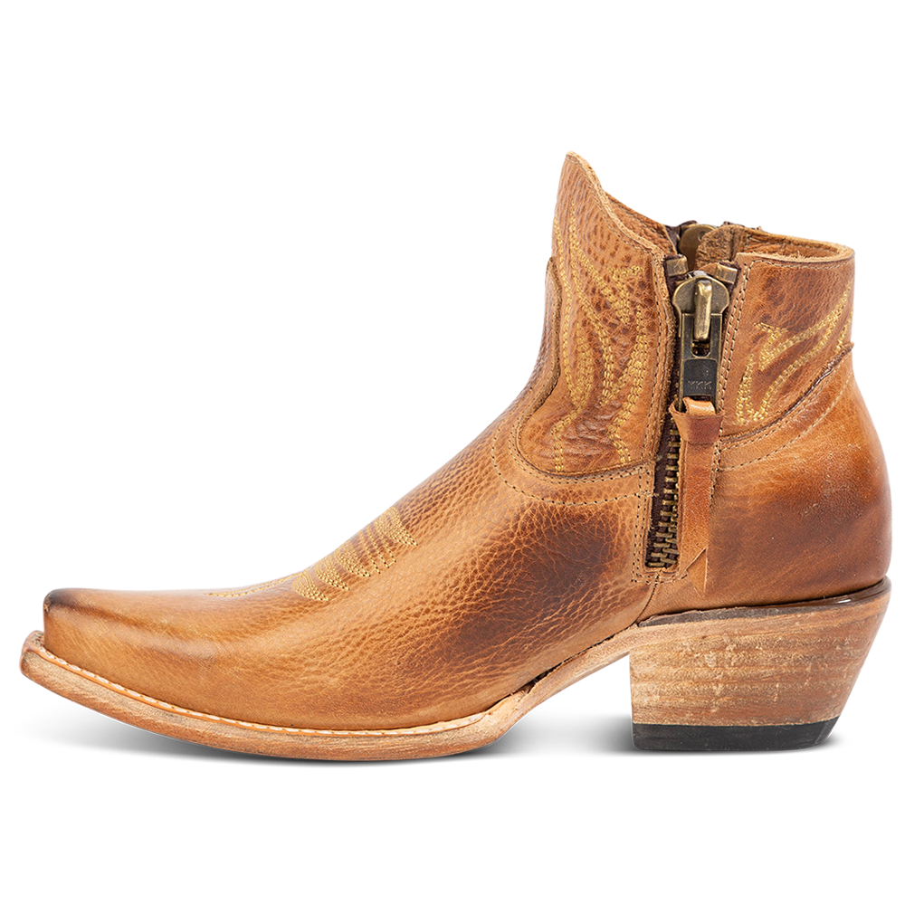 Side view of FREEBIRD women's Wolfie wheat leather bootie with stitch detailing and snip toe construction