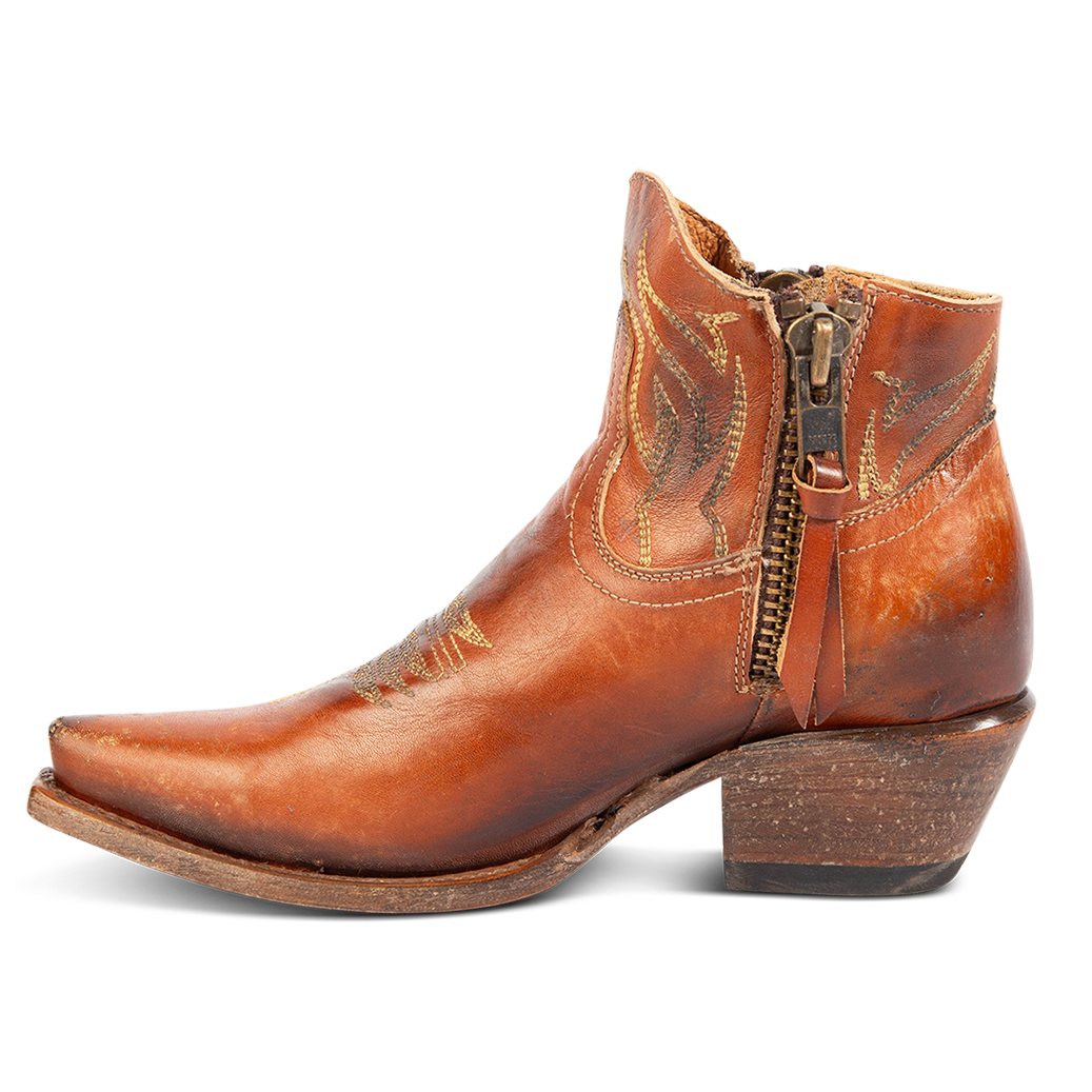 Side view of FREEBIRD women's Wolfie whiskey leather bootie with stitch detailing and snip toe construction