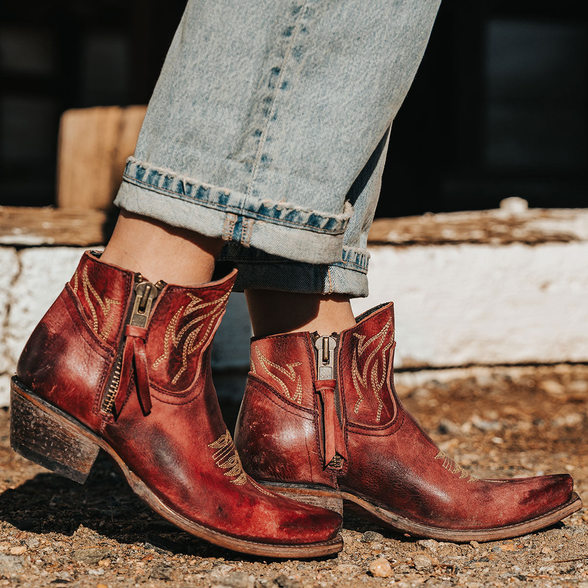 Wine-colored WOLFIE distressed leather western booties with snip toe, side zippers, and stacked heels.