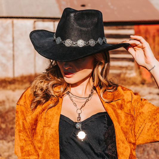 FREEBIRD Wyatt black distressed faux suede hat with a pinched crown, curved brim and engraved coin belt lifestyle