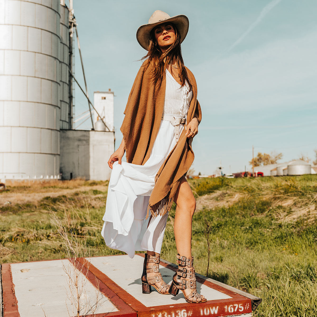 FREEBIRD women's Zeus Taupe Multi a strappy heeled sandal featuring adjustable buckles, leather, and stud detailing lifestyle image