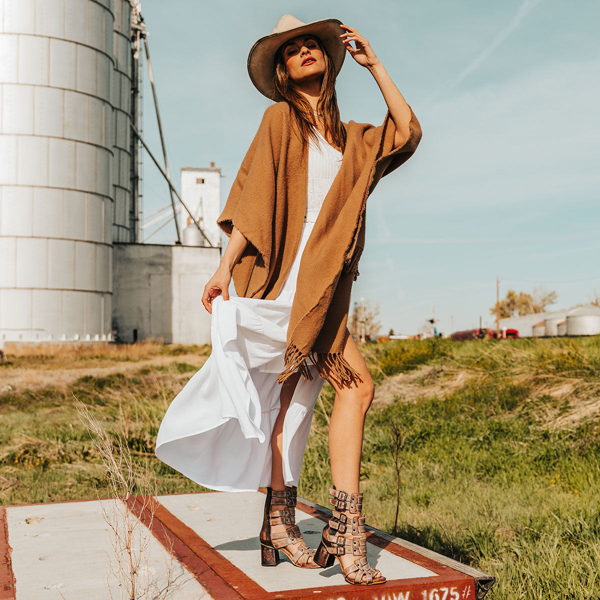 FREEBIRD women's Zeus Taupe Multi a strappy heeled sandal featuring adjustable buckles, leather, and stud detailing lifestyle image