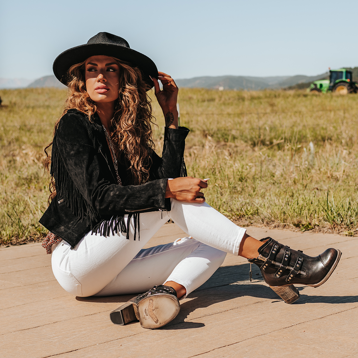 FREEBIRD women's Beckett black full grain leather bootie with inside zip closure, stacked heel, and embellished leather overlays lifestyle
