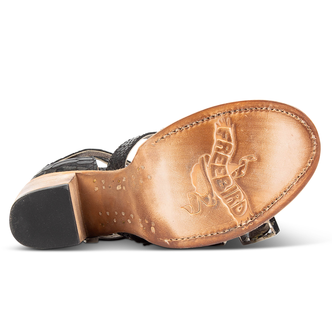 Leather sole imprinted with FREEBIRD on women's Brooklynn black snake sandal