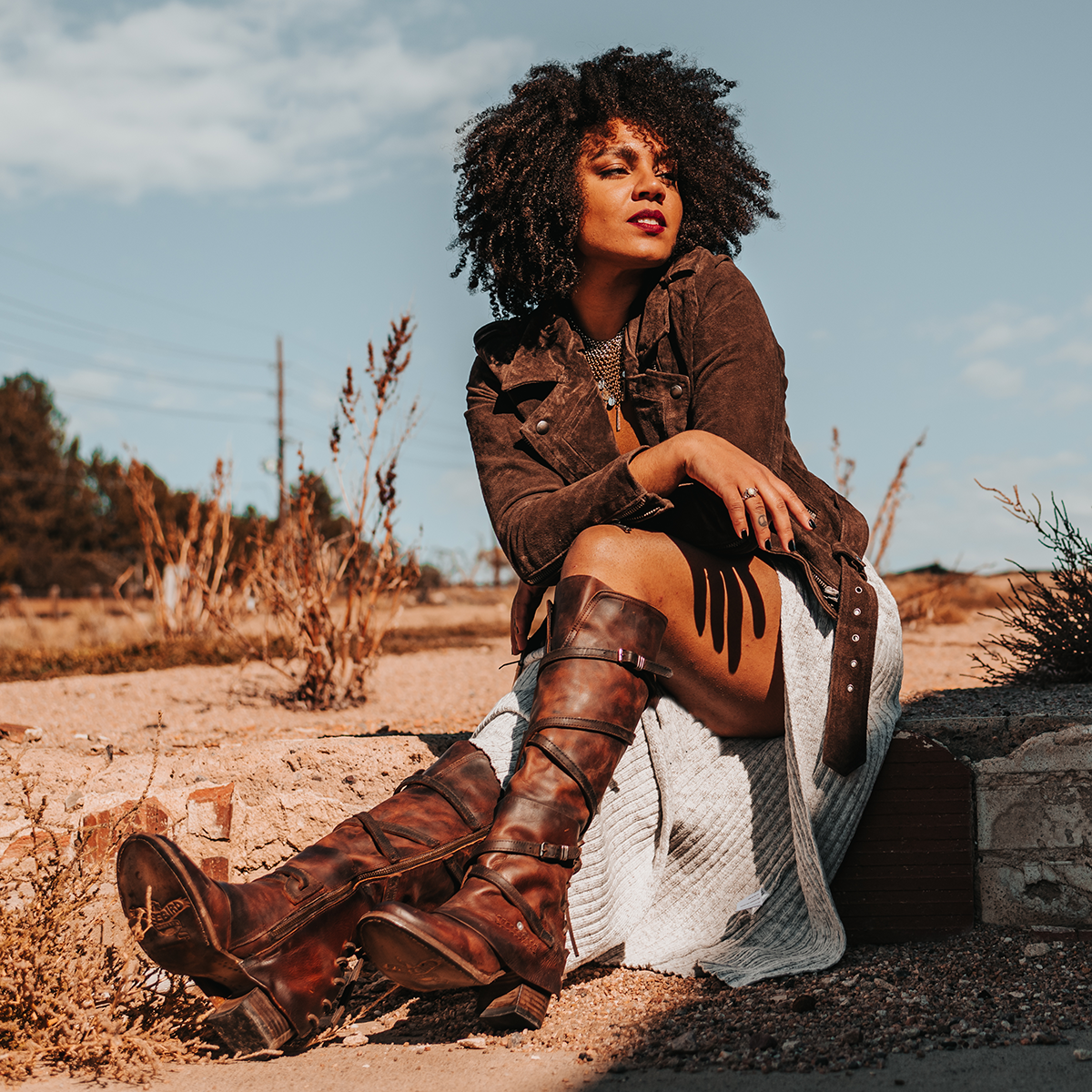 FREEBIRD women's Cassius brown distressed strappy tall boot with back lacing ankle overlay lifestyle image