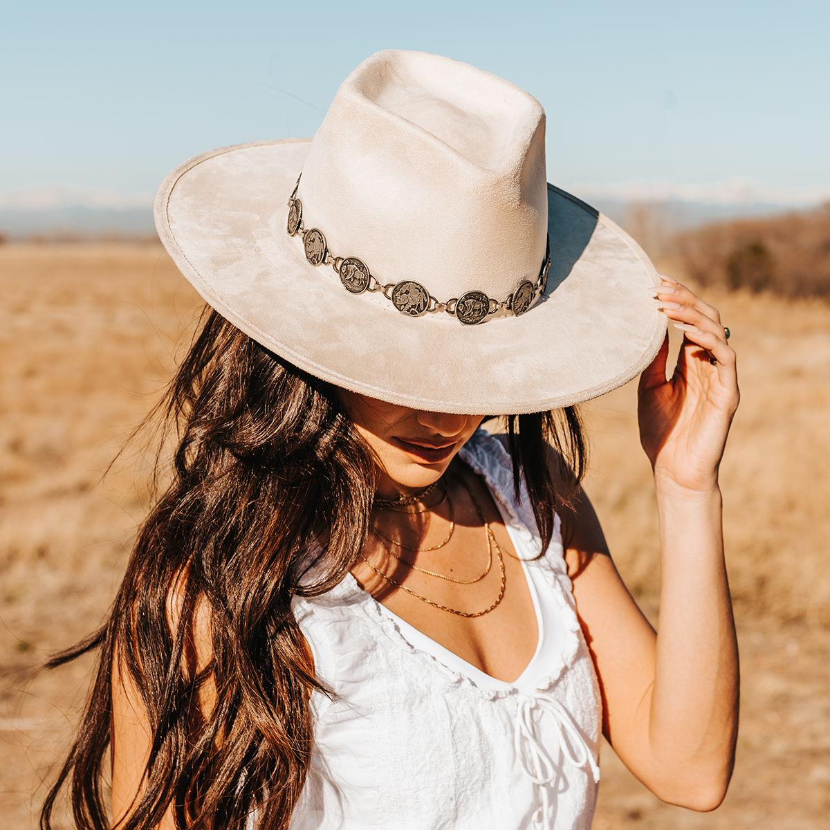 FREEBIRD Gemini beige wide flat-brim hat featuring diamond-shaped crown and metal coin band