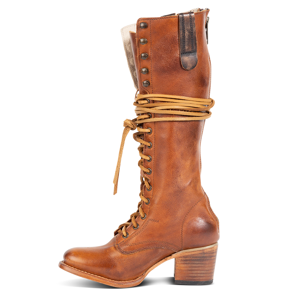 Inside view showing accent pull strap and wrap around leather laces on FREEBIRD women's Grany cognac tall boot