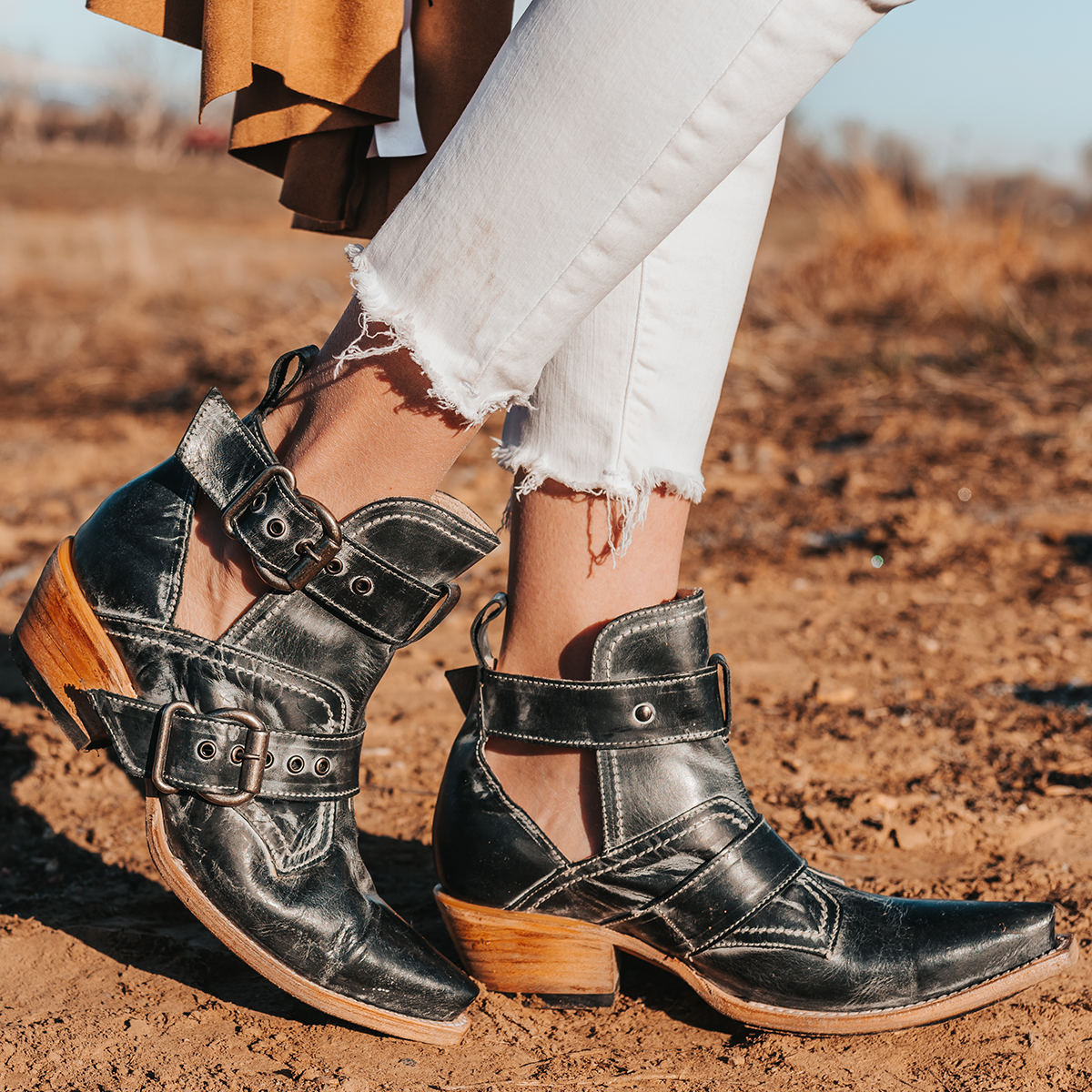 FREEBIRD women's Mayhem black western ankle bootie with exposed sides, adjustable metal buckles, and snip toe