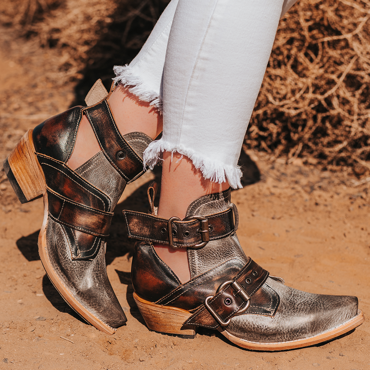 FREEBIRD women's Mayhem ice multi western ankle bootie with exposed sides, adjustable metal buckles, and snip toe