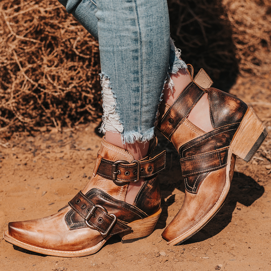 FREEBIRD women's Mayhem taupe multi western ankle bootie with exposed sides, adjustable metal buckles, and snip toe