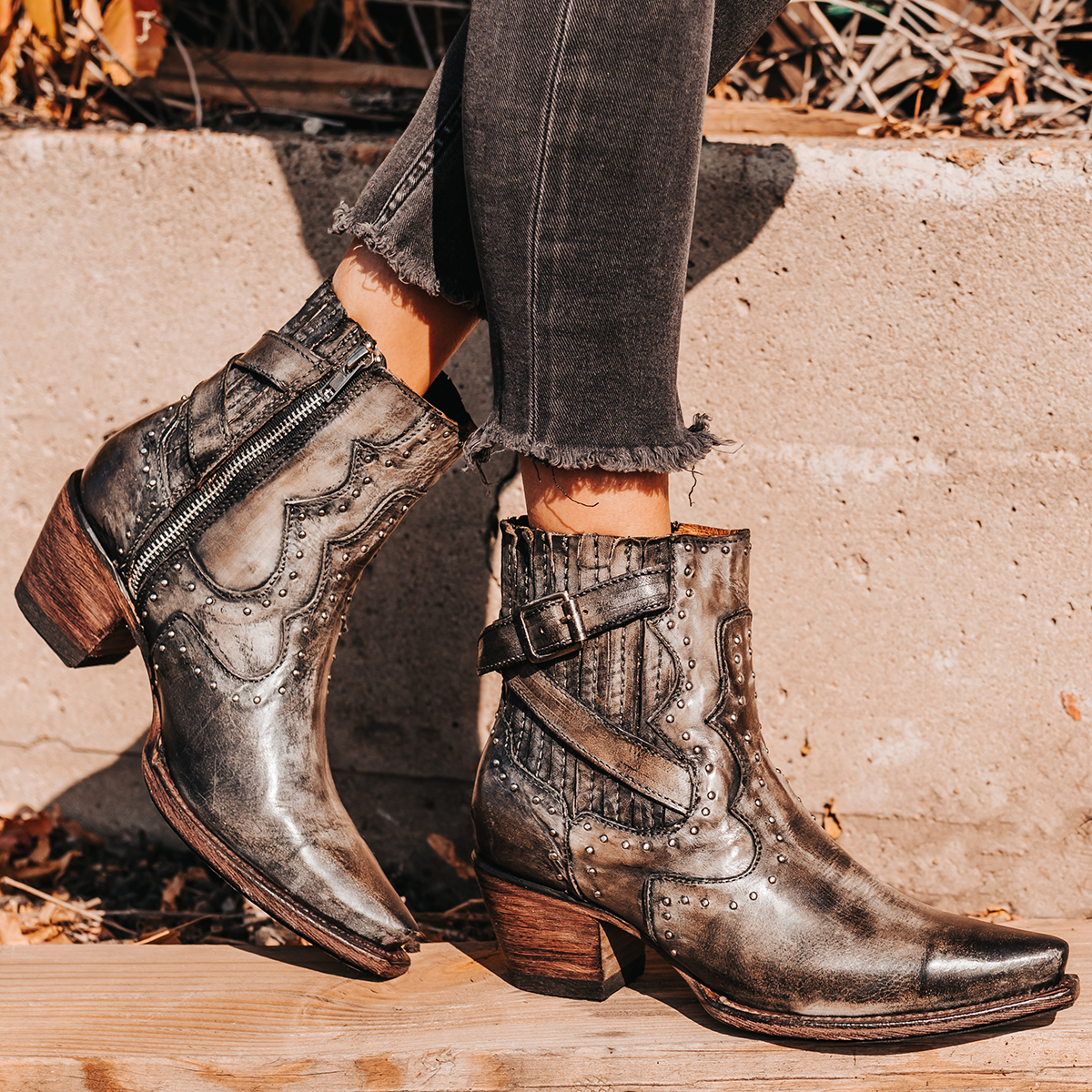 FREEBIRD women's Morgan stone leather ankle bootie with silver stud embellishments, gore detailing, and buckle straps