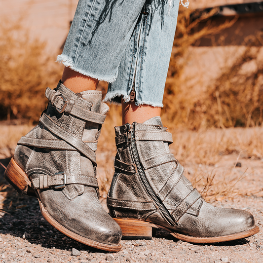 FREEBIRD women's Raine stone full grain leather bootie with inside zip closure, wooden heel, and leather overlays with metal buckles